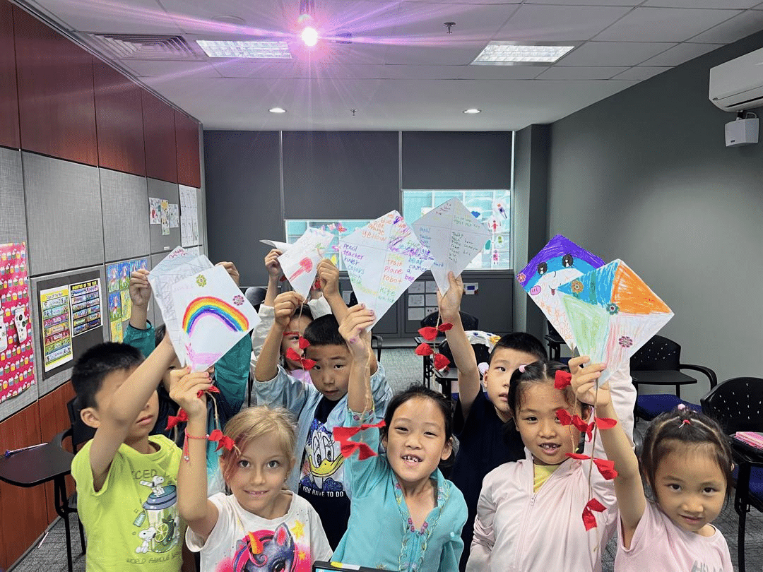 Children displaying their work while learning English at Stratford's English summer camp in Malaysia